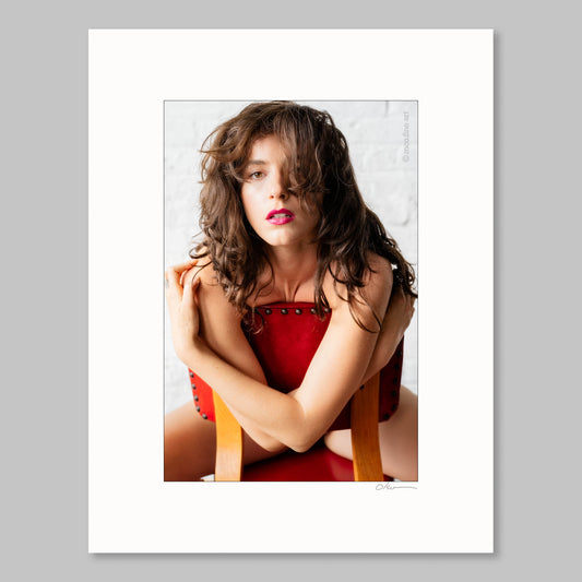 Woman sitting on a chair with a white background