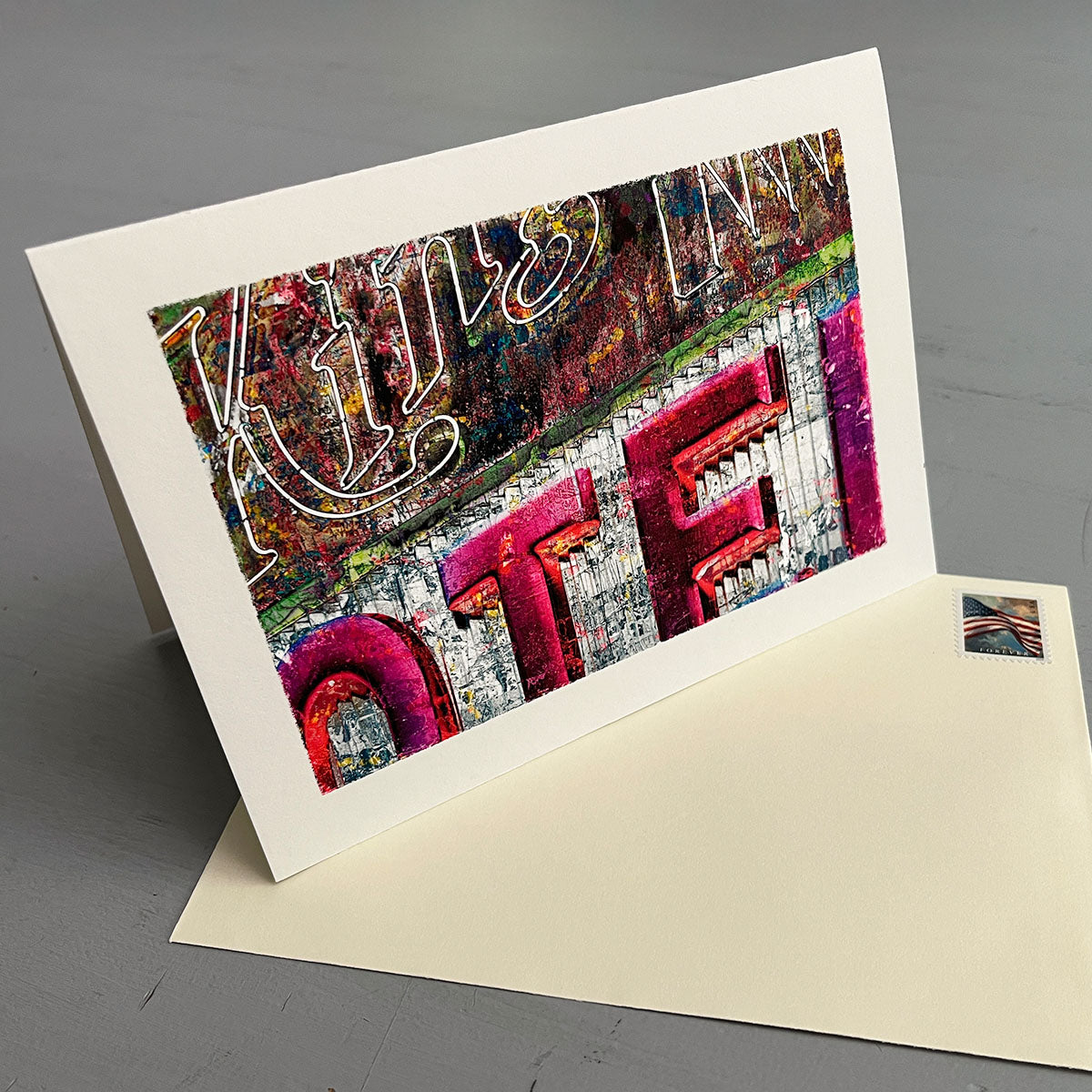 Greeting card with colorful 'Motel Sign' text design on a gray background